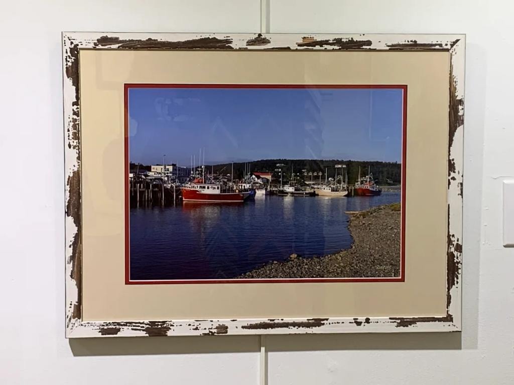 Framed fishing boats harbor coastal village